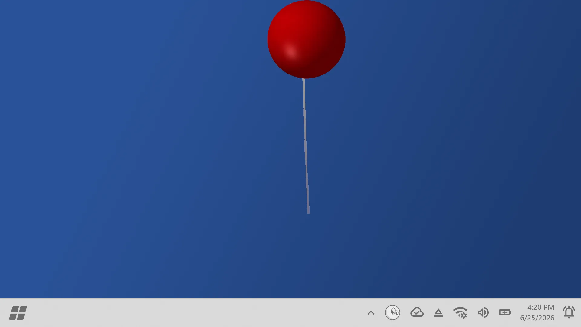 A red balloon on a string drifting up the desktop