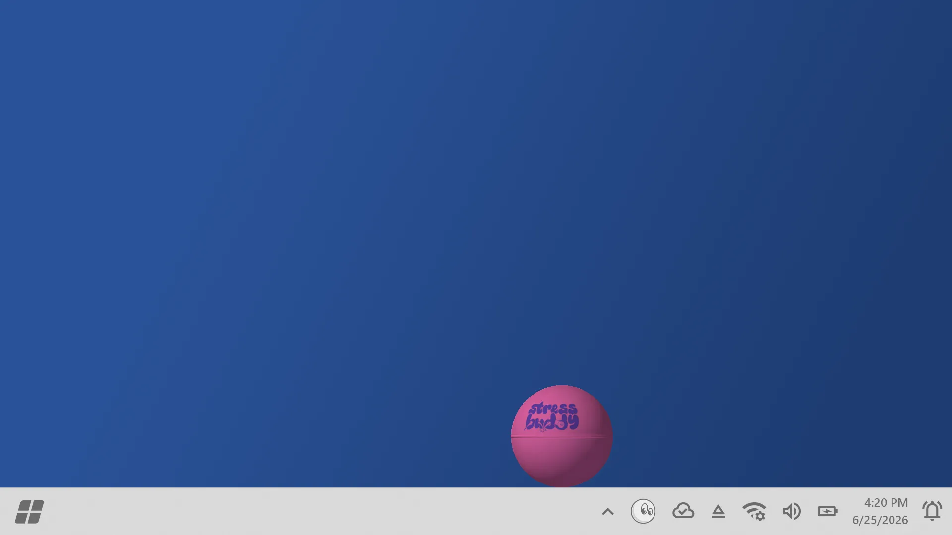 A pink rubber bouncy ball printed with the Stress Buddy logo, resting on the taskbar